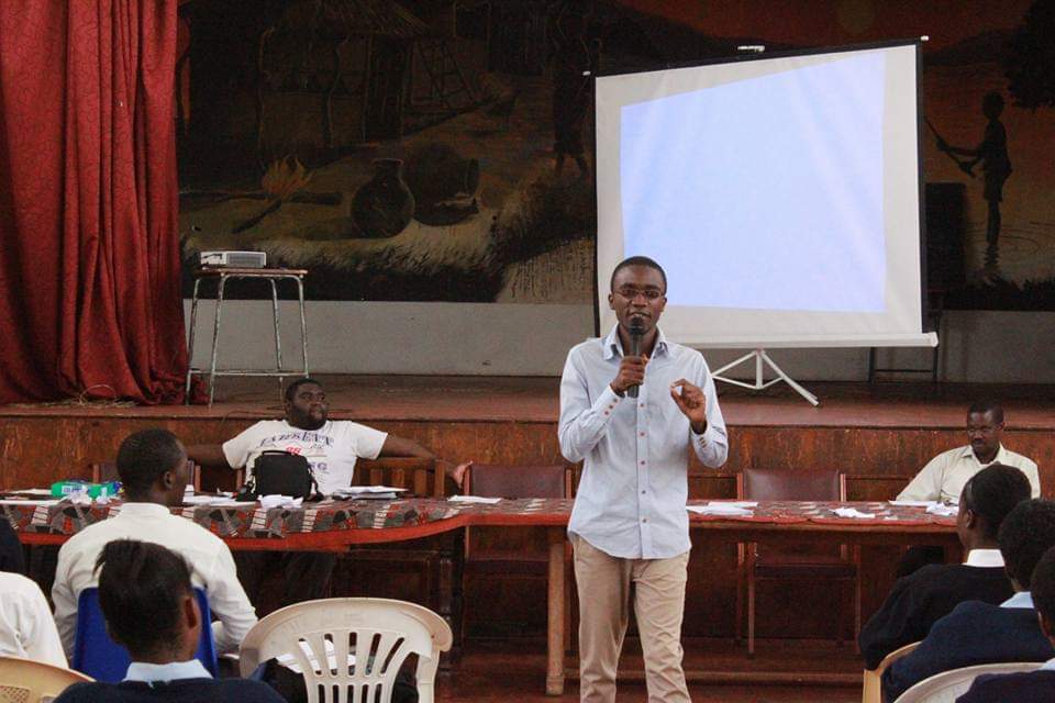 Shuko Musemangezhi speaking to students in a school hall